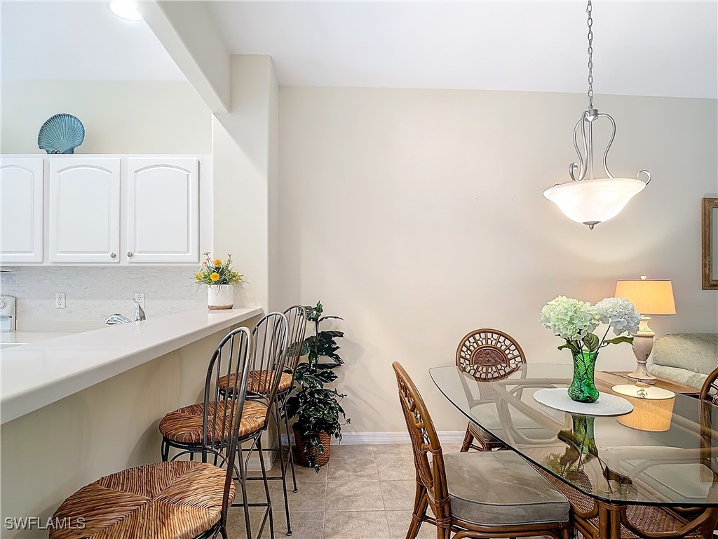 3600 Rue Alec Loop, Unit 4 North Fort Myers, FL 33917 - Photo 14 of 40 a view of a dining room with furniture and chandelier