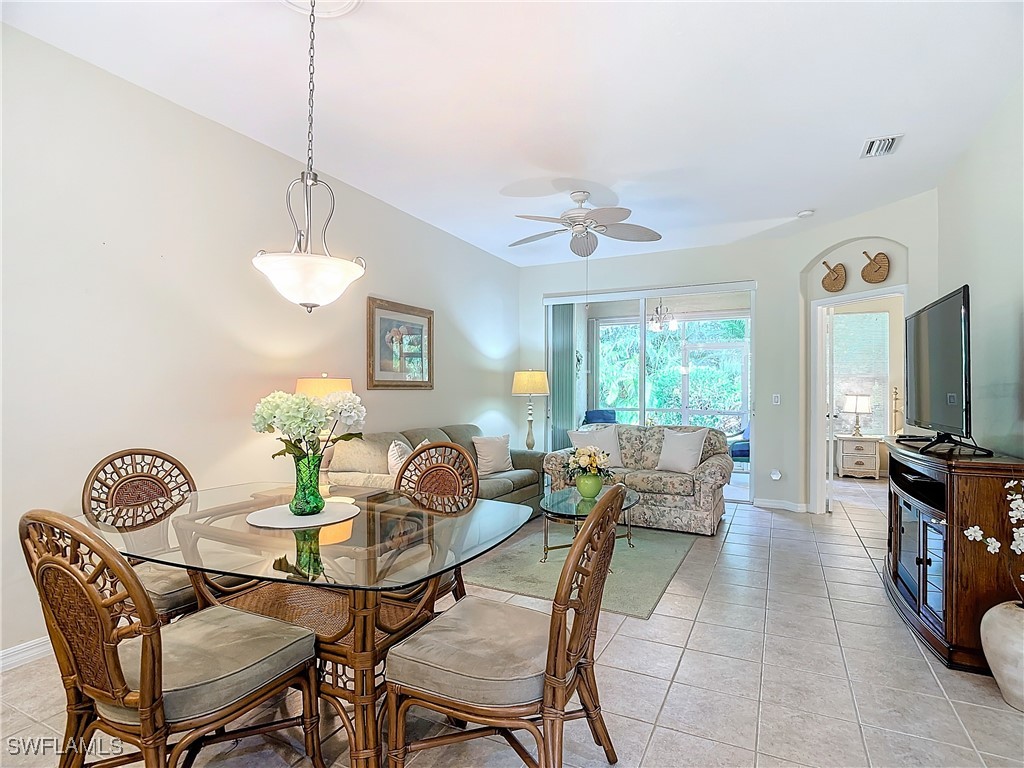 3600 Rue Alec Loop, Unit 4 North Fort Myers, FL 33917 - Photo 15 of 40 a dining room with furniture a window and a chandelier