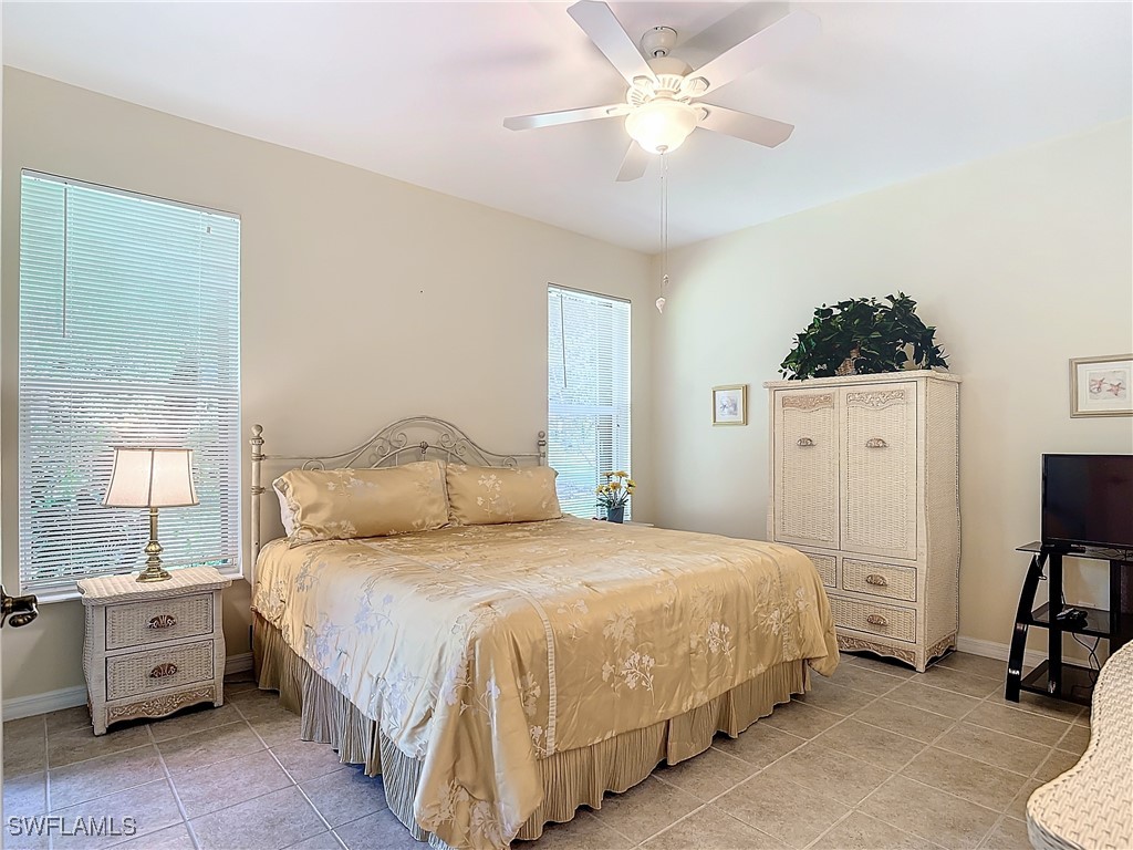3600 Rue Alec Loop, Unit 4 North Fort Myers, FL 33917 - Photo 18 of 40 a bedroom with a bed and a chandelier