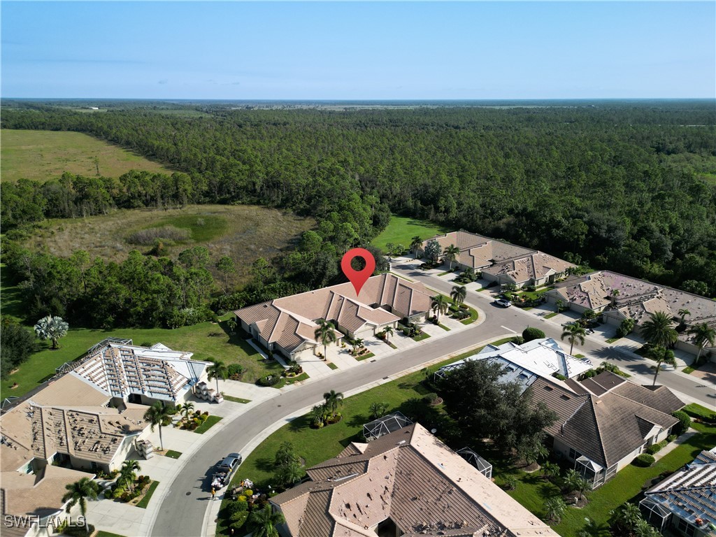 3600 Rue Alec Loop, Unit 4 North Fort Myers, FL 33917 - Photo 2 of 40 an aerial view of a house with a garden and mountain view in back