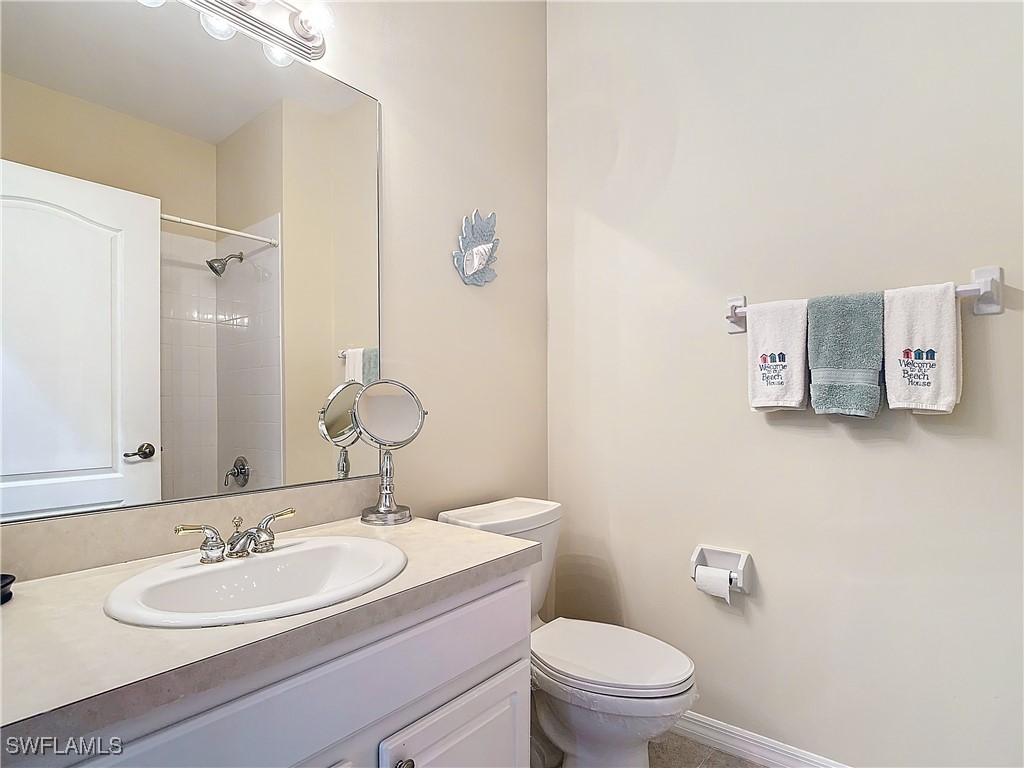 3600 Rue Alec Loop, Unit 4 North Fort Myers, FL 33917 - Photo 22 of 40 a bathroom with a granite countertop sink and a mirror with toilet