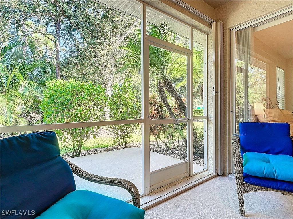 3600 Rue Alec Loop, Unit 4 North Fort Myers, FL 33917 - Photo 26 of 40 a balcony view with a couch and large windows with wooden floor