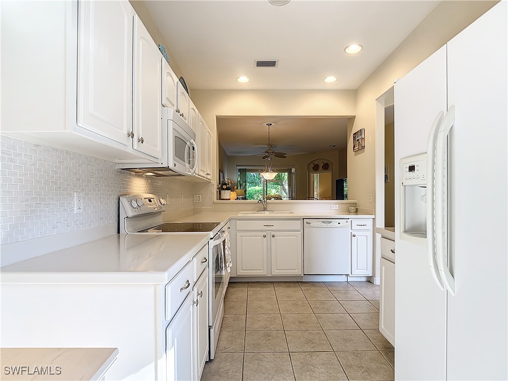 3600 Rue Alec Loop, Unit 4 North Fort Myers, FL 33917 - Photo 9 of 40 a kitchen with a sink and cabinets