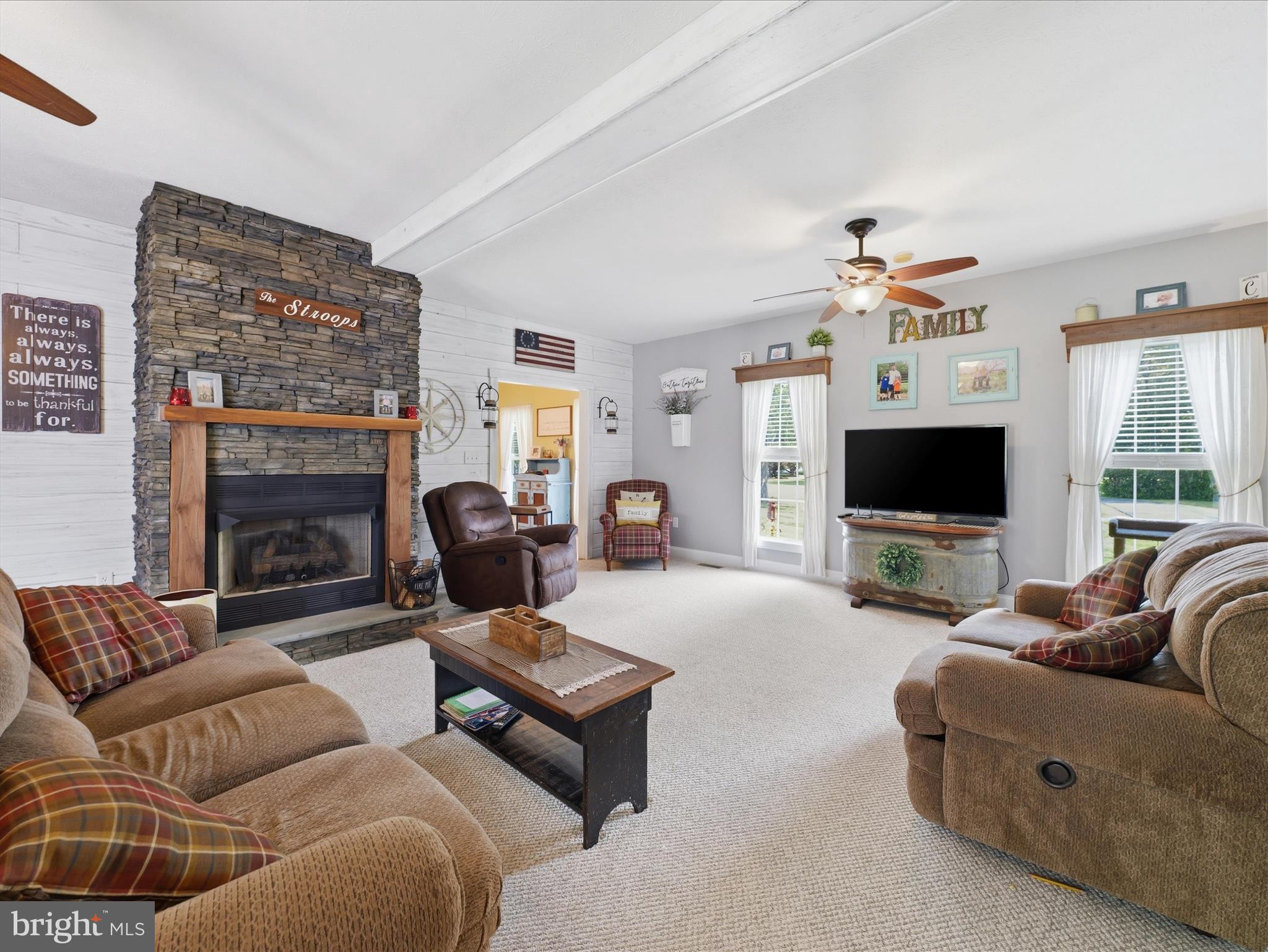 726 Doe Run Road Inwood, WV 25428 - Photo 39 of 68 a living room with furniture a flat screen tv and a fireplace