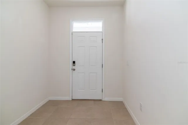 a view of a kitchen with a sink windows and a chandelier