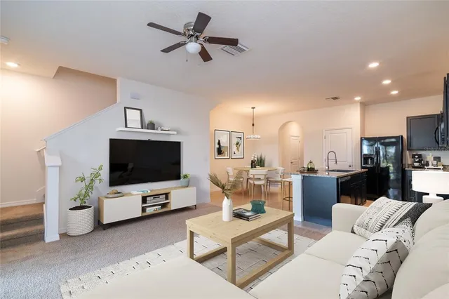 a view of a kitchen with a sink and a refrigerator