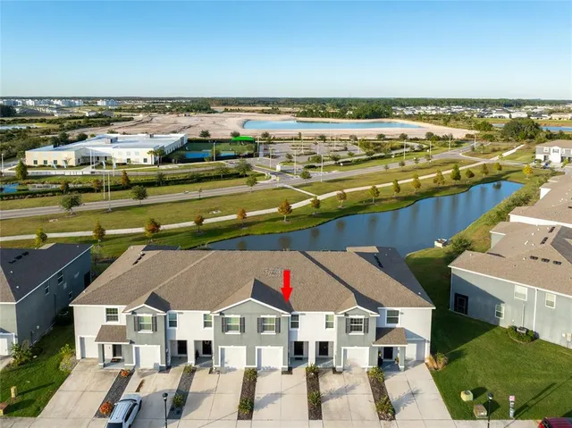 a view of residential houses with outdoor space and ocean view