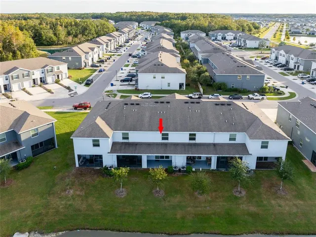 an aerial view of residential houses with outdoor space and swimming pool