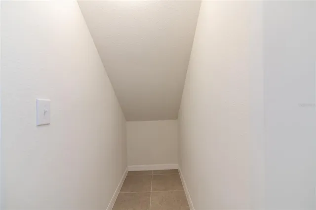 an aerial view of a swimming pool with outdoor seating and yard