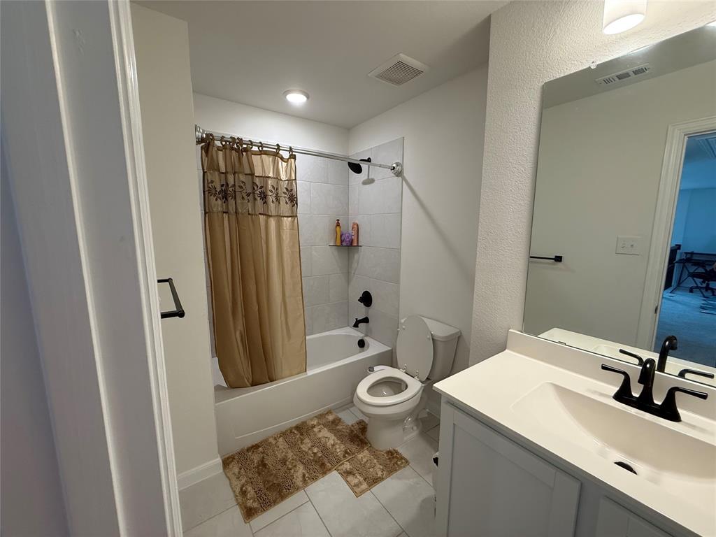 2006 Placerville Street Forney, TX 75126 - Photo 31 of 35 Bathroom featuring a white vanity with an integrated sink, matte black faucet, and a large wall mirror