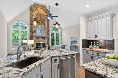 a kitchen with a sink stove and cabinets