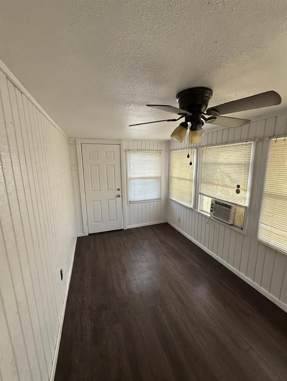 7443 Anderlan Road The Colony, TX 75056 - Photo 7 of 15 an empty room with a wooden door and windows