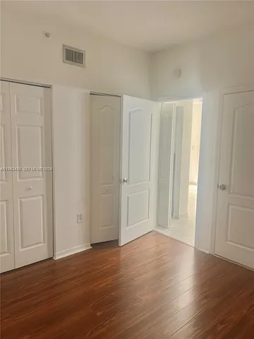 a view of wooden floor and windows in a room