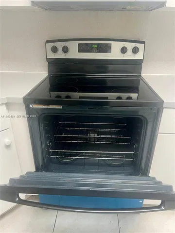 a stove top oven sitting inside of a kitchen