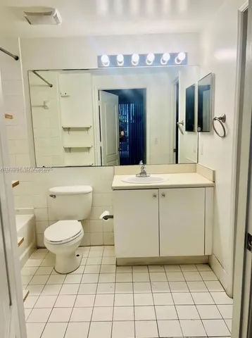 a bathroom with a sink toilet and mirror