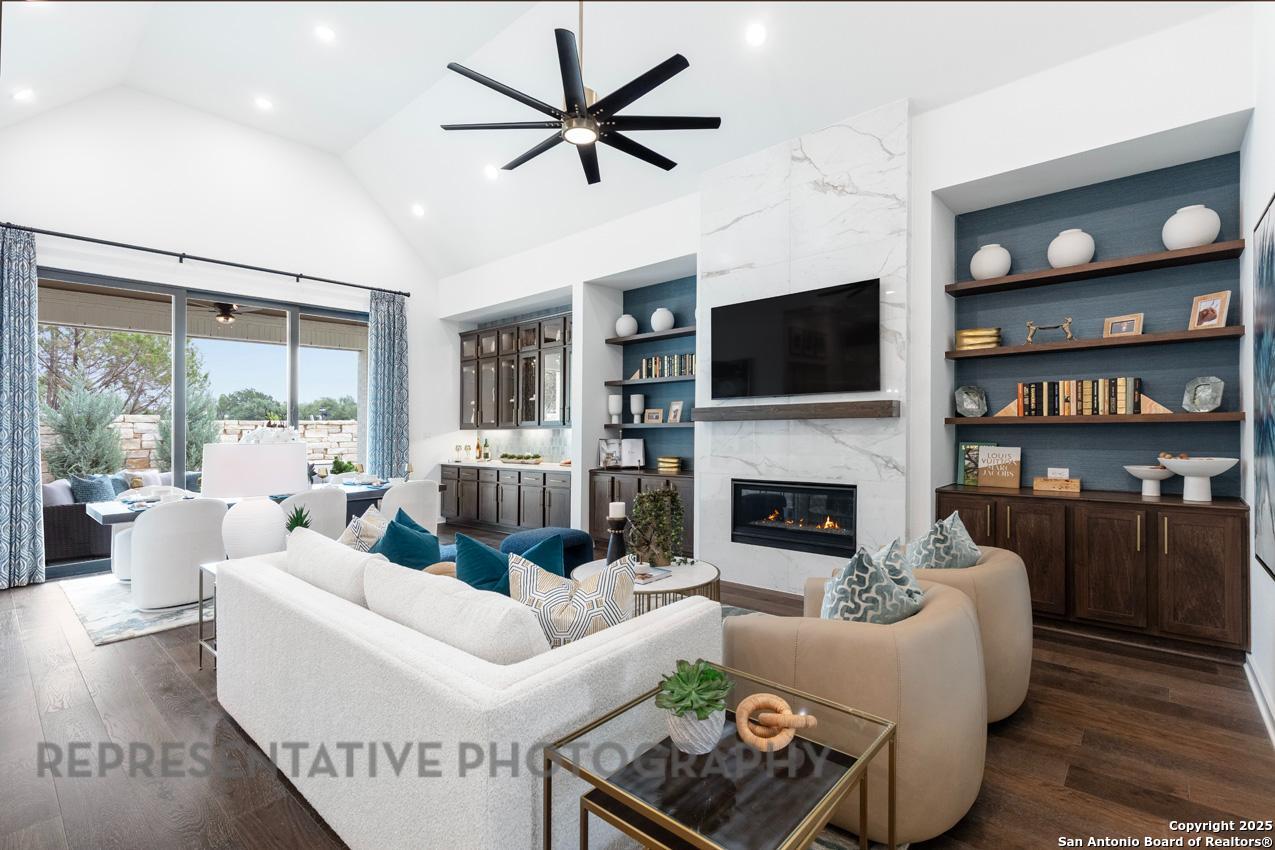 235 Boulder Creek Boerne, TX 78006 - Photo 13 of 40 a living room with furniture a fireplace and a flat screen tv