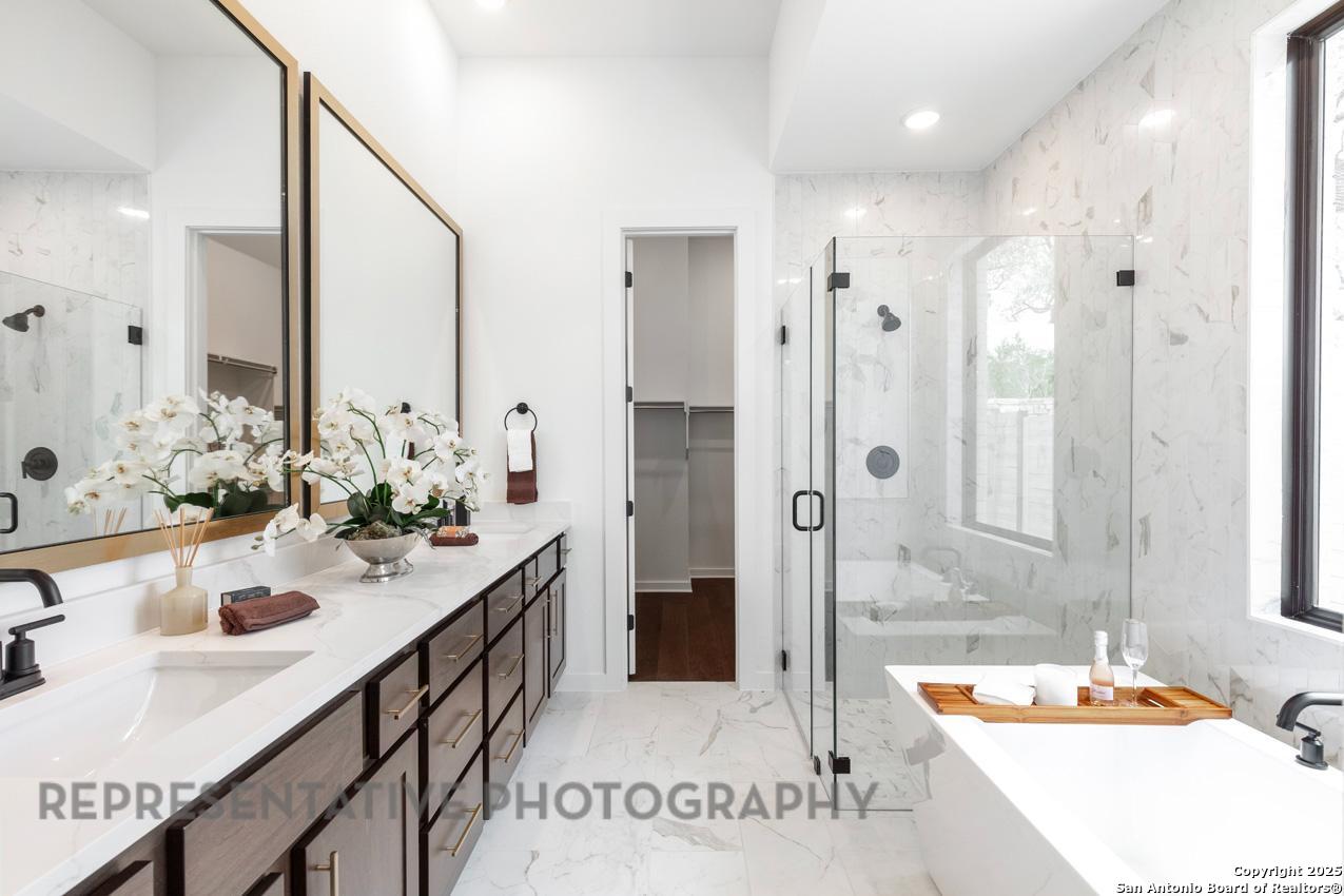 235 Boulder Creek Boerne, TX 78006 - Photo 17 of 40 a bathroom with a tub sink and mirror