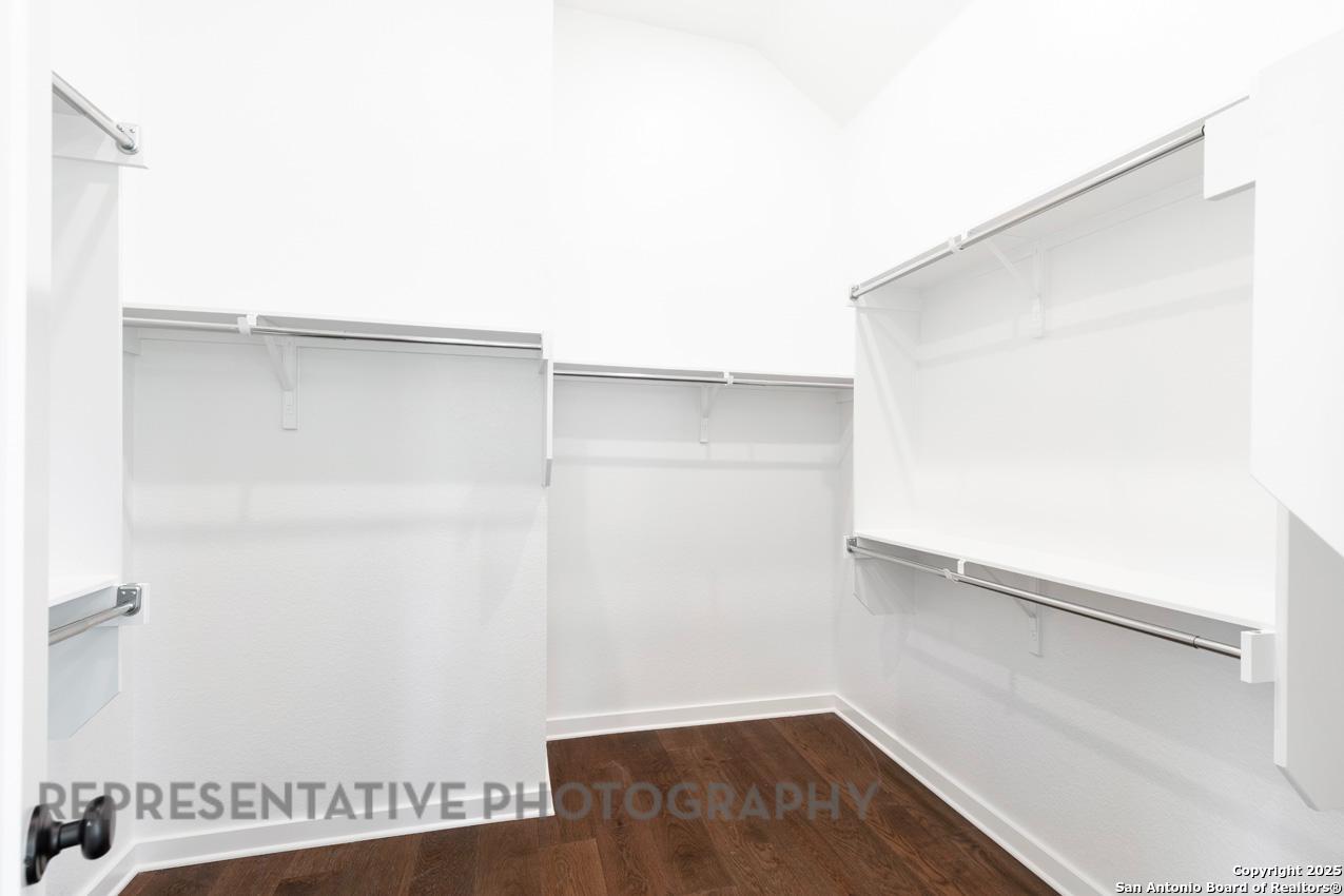235 Boulder Creek Boerne, TX 78006 - Photo 19 of 40 a view of walk in closet with empty racks