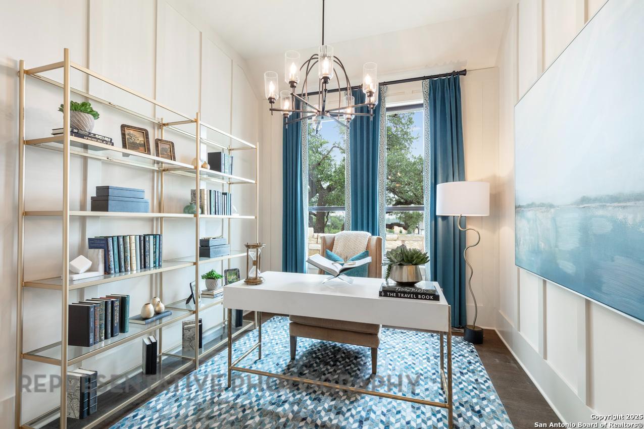 235 Boulder Creek Boerne, TX 78006 - Photo 20 of 40 a living room with furniture a rug and a chandelier