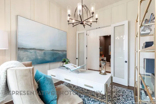 a room with granite countertop furniture and a chandelier
