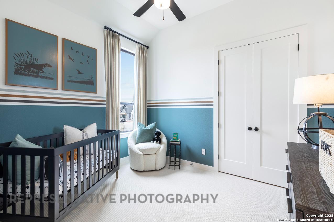 235 Boulder Creek Boerne, TX 78006 - Photo 29 of 40 a view of a bedroom with wooden floor and windows