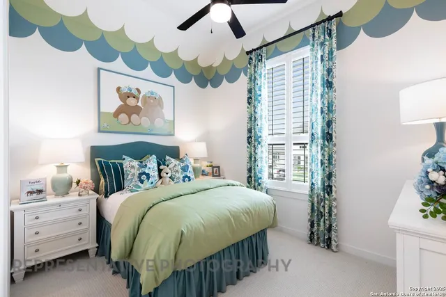 a bedroom with a bed and a painting on the wall