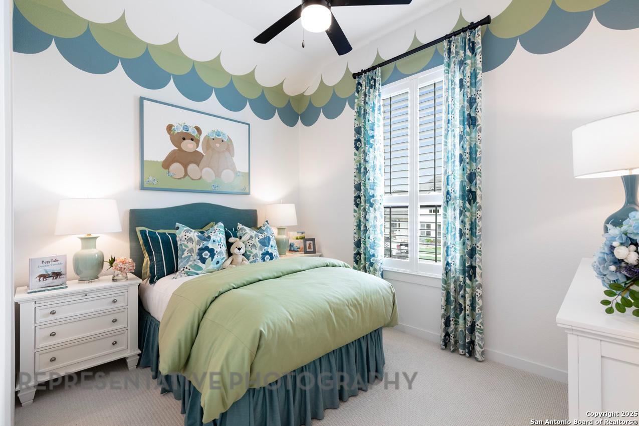 235 Boulder Creek Boerne, TX 78006 - Photo 30 of 40 a bedroom with a bed and a painting on the wall