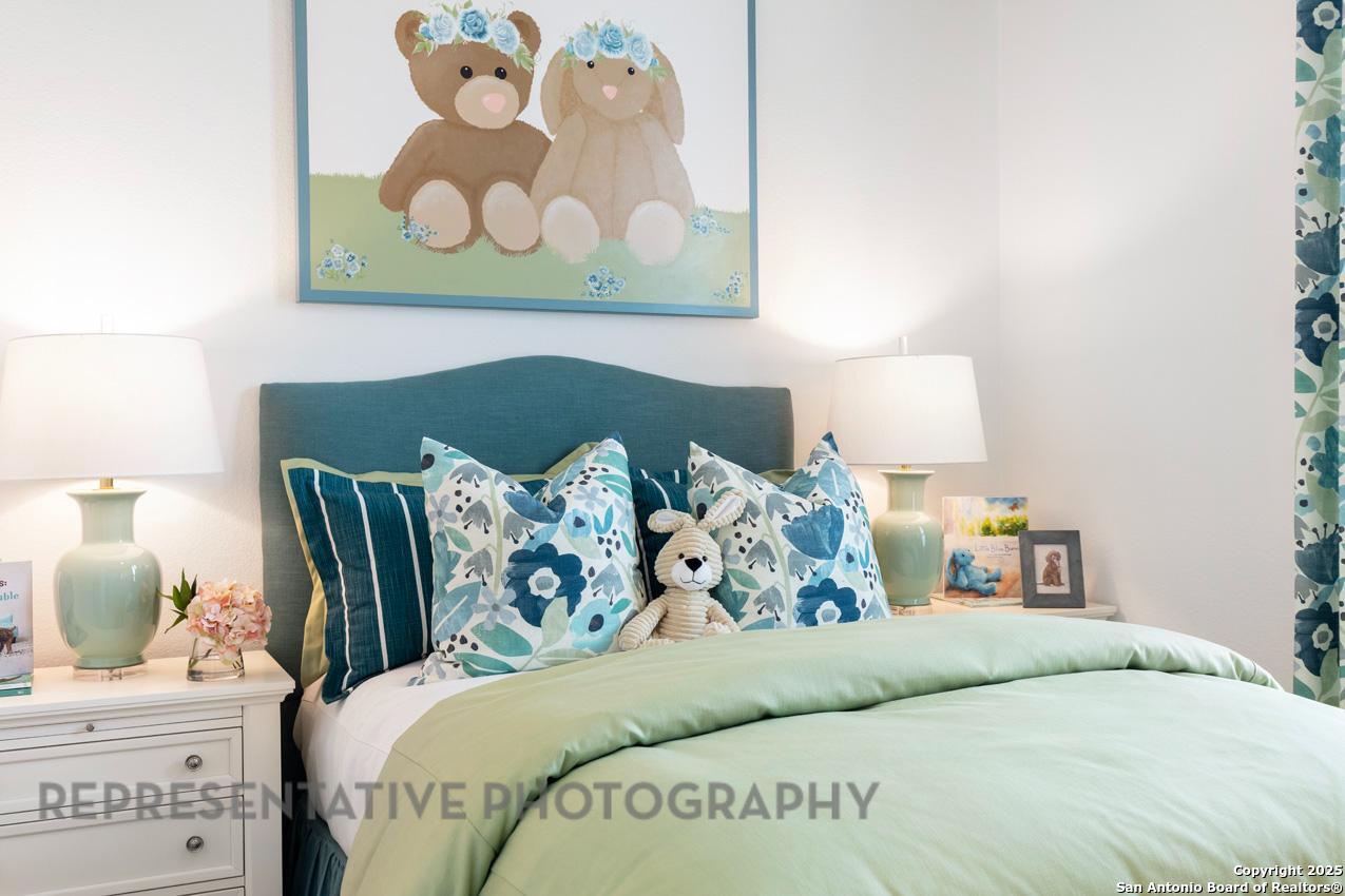 235 Boulder Creek Boerne, TX 78006 - Photo 31 of 40 a bedroom with a bed and a painting on the wall