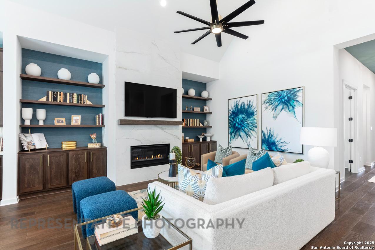 235 Boulder Creek Boerne, TX 78006 - Photo 10 of 40 a living room with furniture a fireplace and a flat screen tv