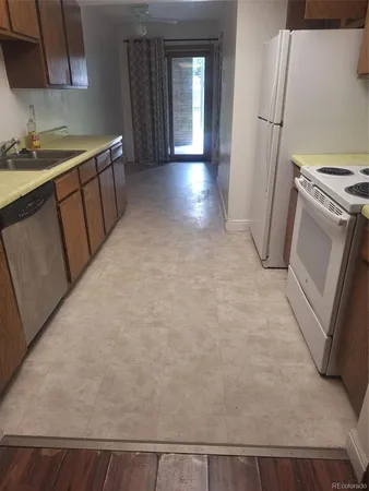 a view of a kitchen with a sink stove and refrigerator