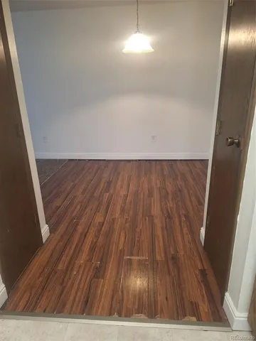 a view of room with wooden floor