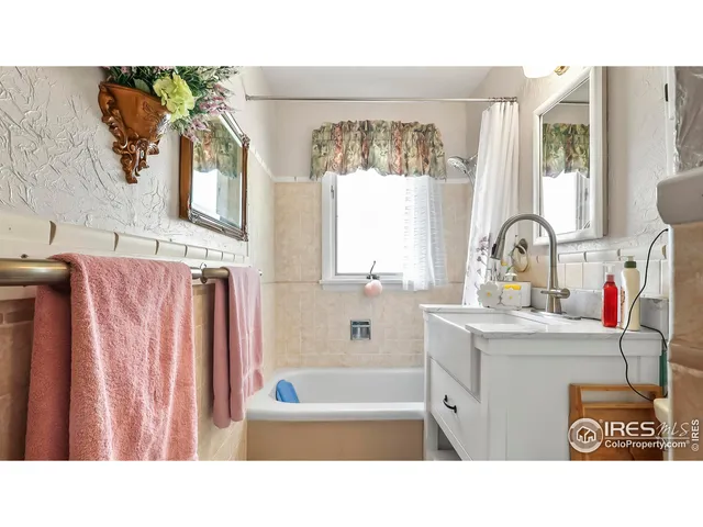 a bathroom with a sink a mirror and a shower