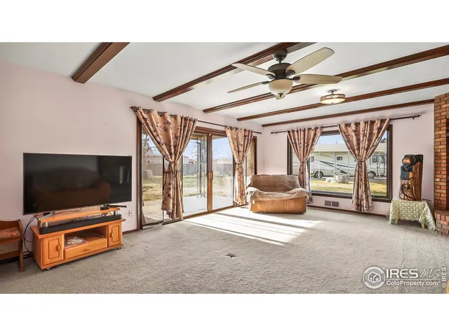 a bedroom with furniture and large window