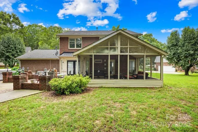 a view of a house with sitting area and garden