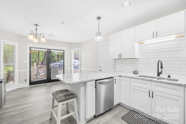 a kitchen with a sink window and cabinets