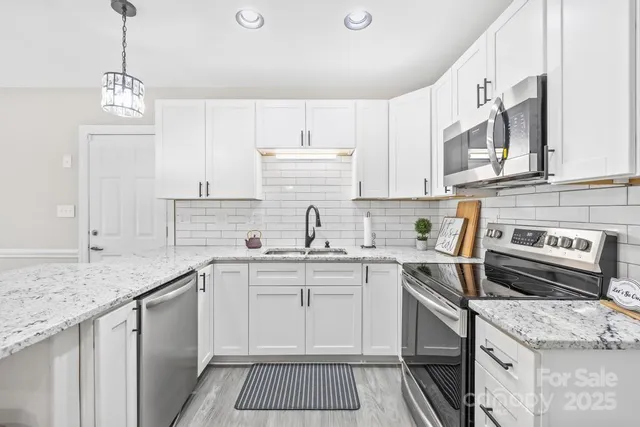 a kitchen with a sink stove and cabinets
