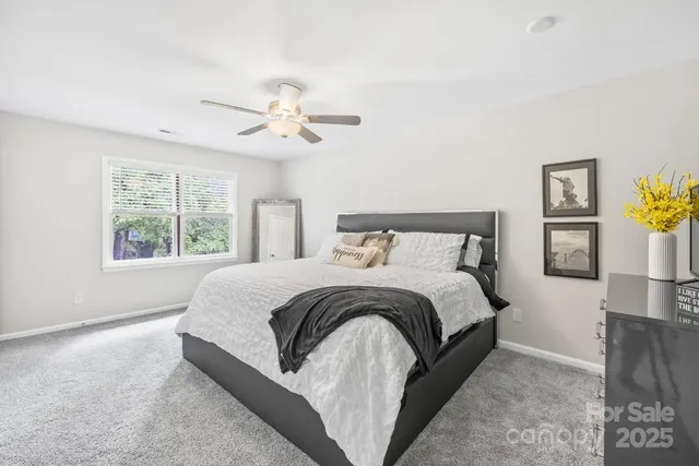 a spacious bedroom with a bed and a window