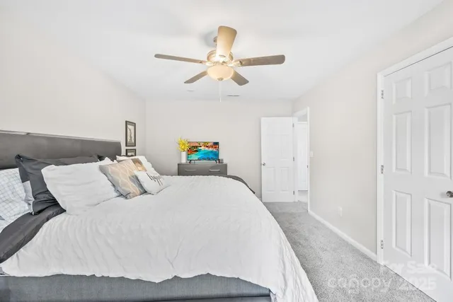 a bedroom with a bed and ceiling fan