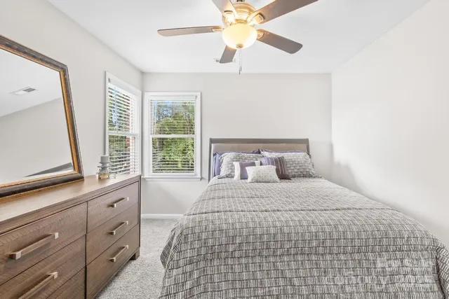 a bedroom with a large bed and a window