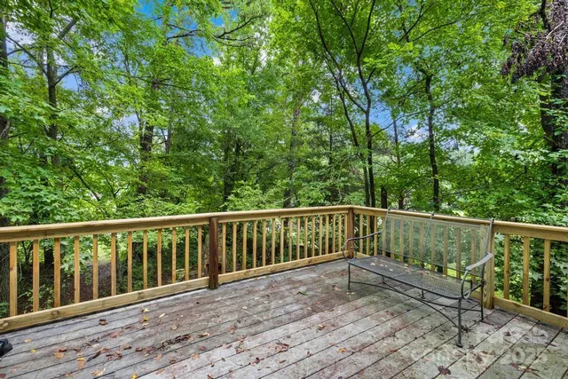 a balcony with wooden floor and fence