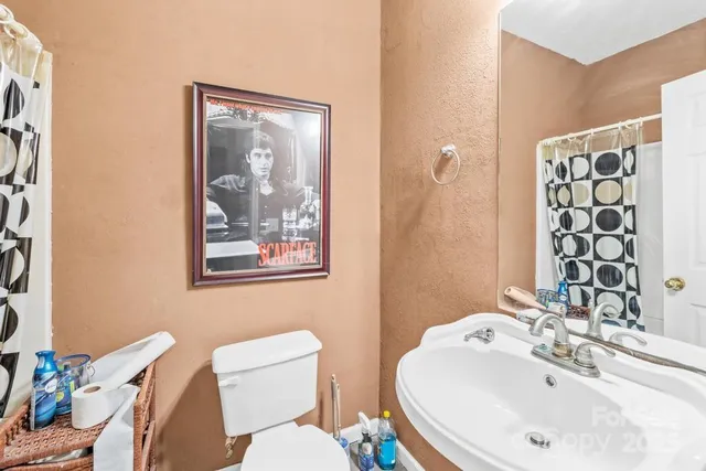 a bathroom with a toilet a sink and mirror