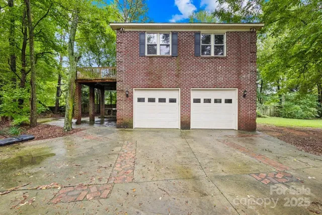 a view of a house with a yard and a tree