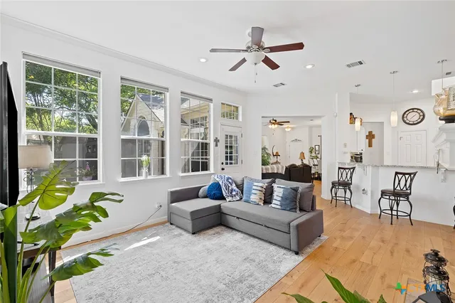 a spacious bathroom with a granite countertop sink a toilet a mirror and bathtub