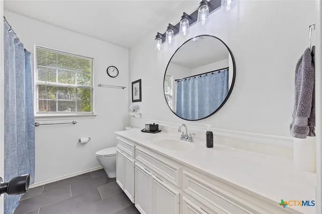 a view of a chair and table under an umbrella in the garden
