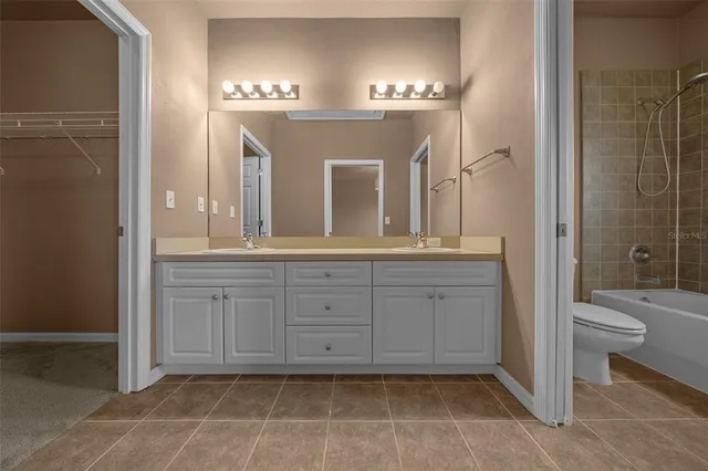 a spacious bathroom with a mirror a toilet a sink and vanity