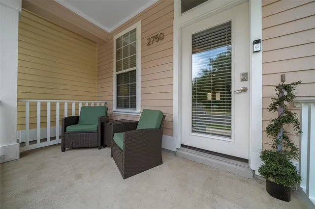 a balcony with furniture and a potted plant