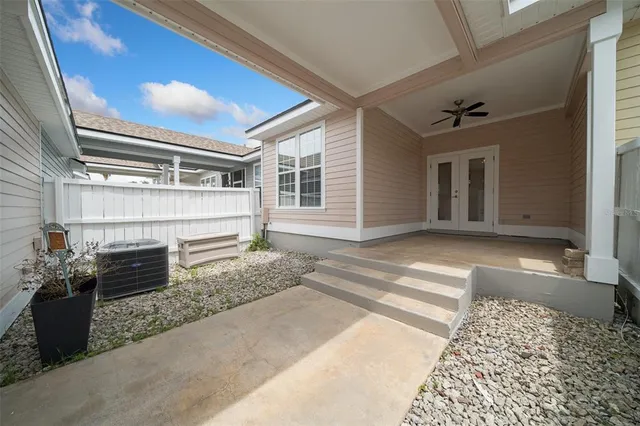 a view of a room with gym equipment and a porch
