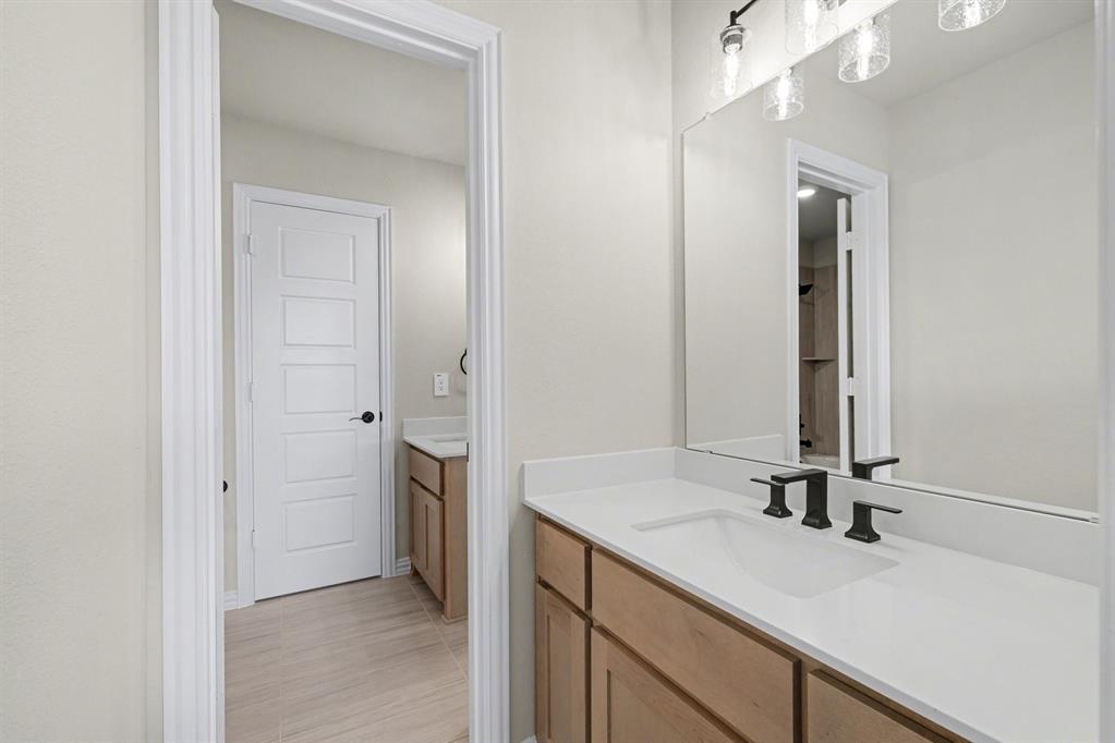 7041 Champion Road Midlothian, TX 76065 - Photo 26 of 30 a bathroom with a sink and a mirror