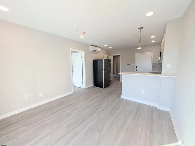 a view of a kitchen with a sink and a refrigerator