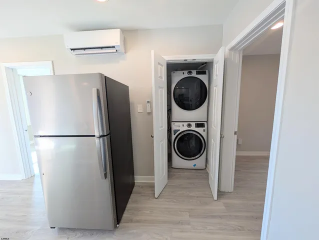 a view of a refrigerator and washer in a kitchen